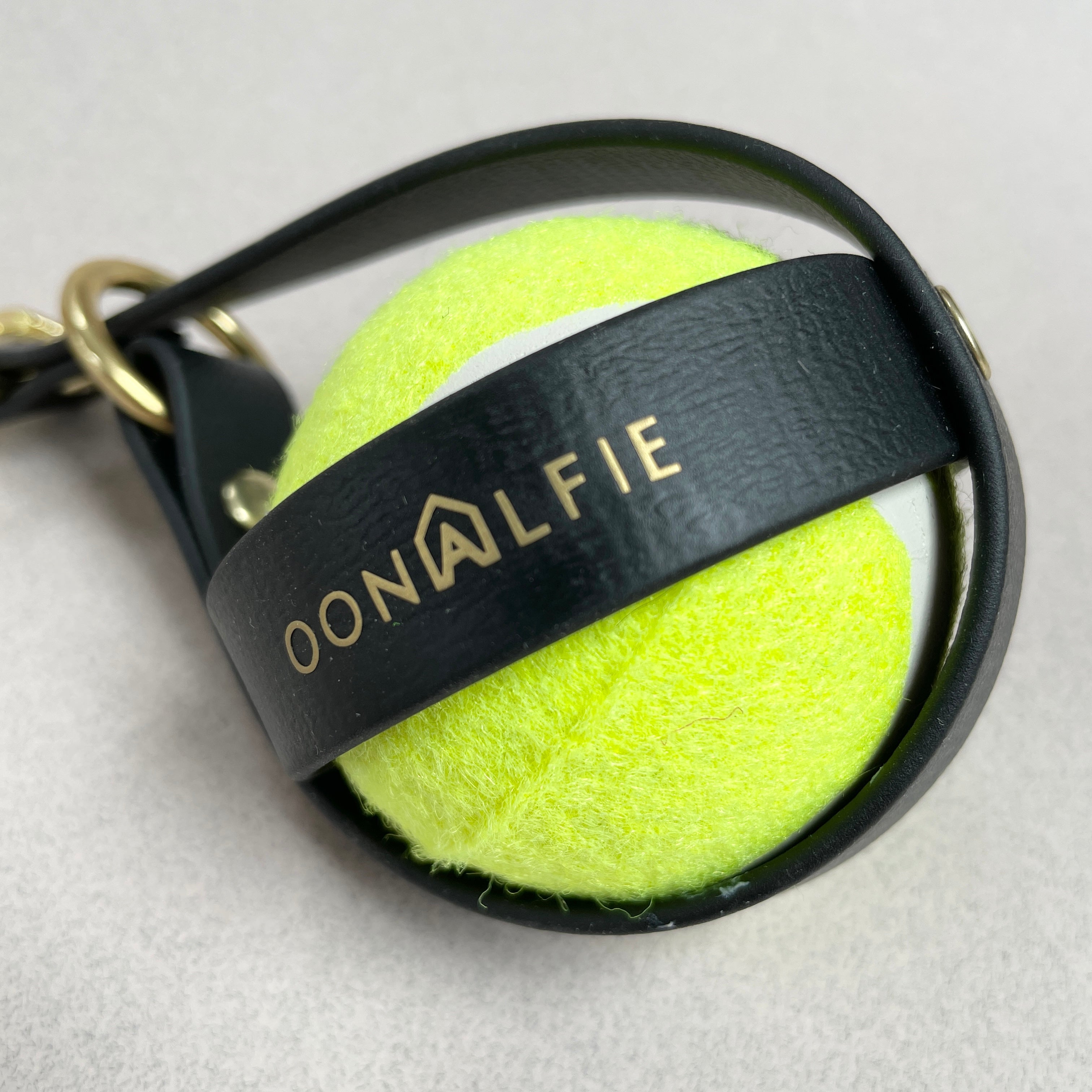 Dog ball holster by Oonalfie showing opening mechanism and rope loop attachment