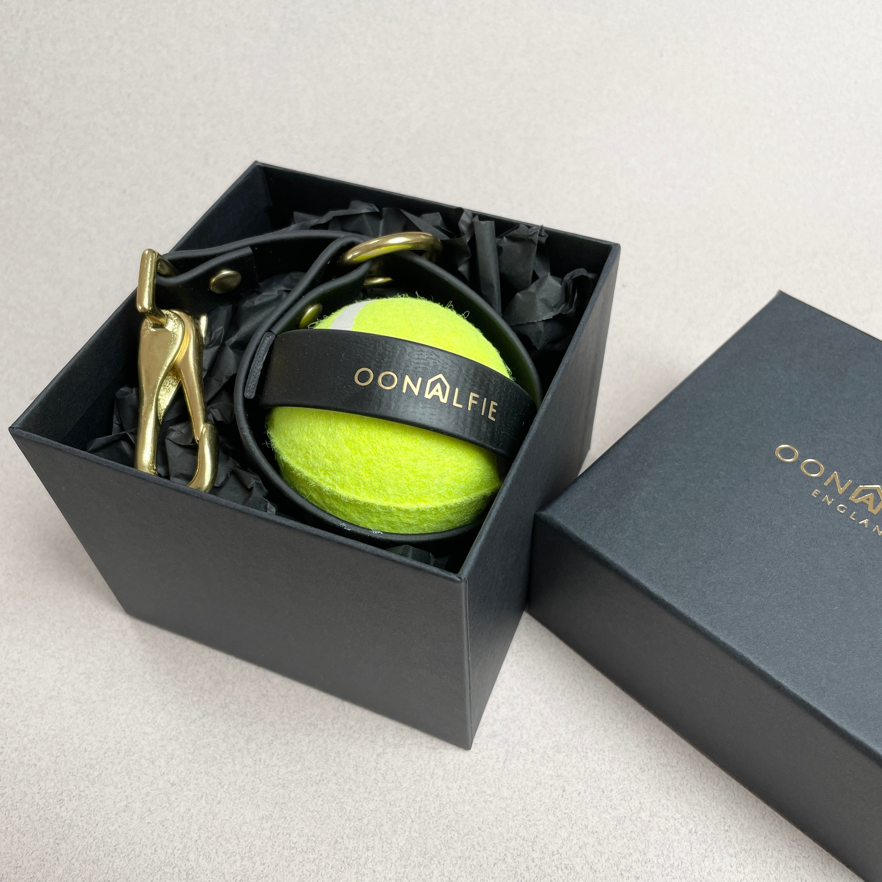 Oonalfie dog ball holster in eco-friendly packaging with brand card