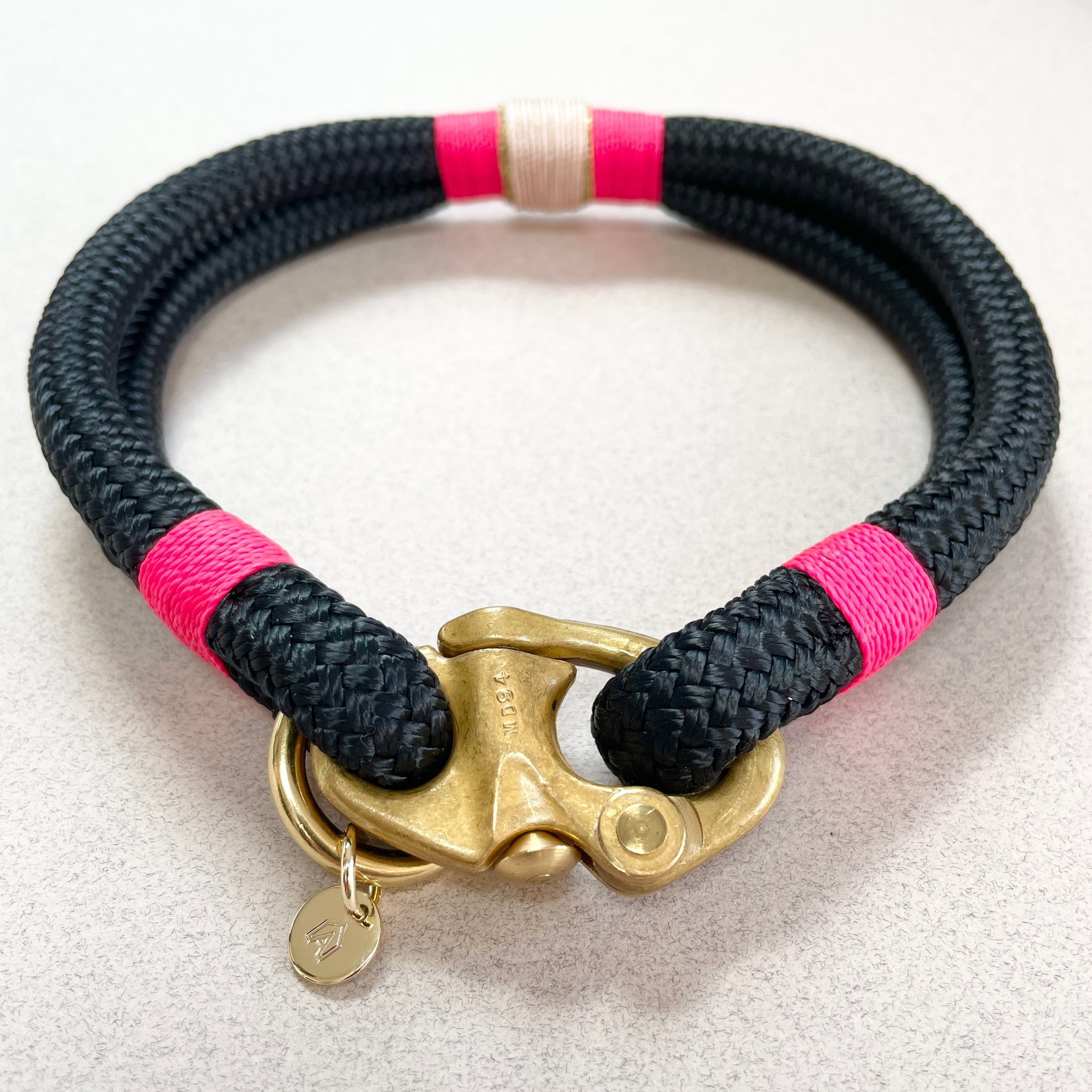Close-up of Bahamas collar showing hot pink and gold whipping detail on navy rope