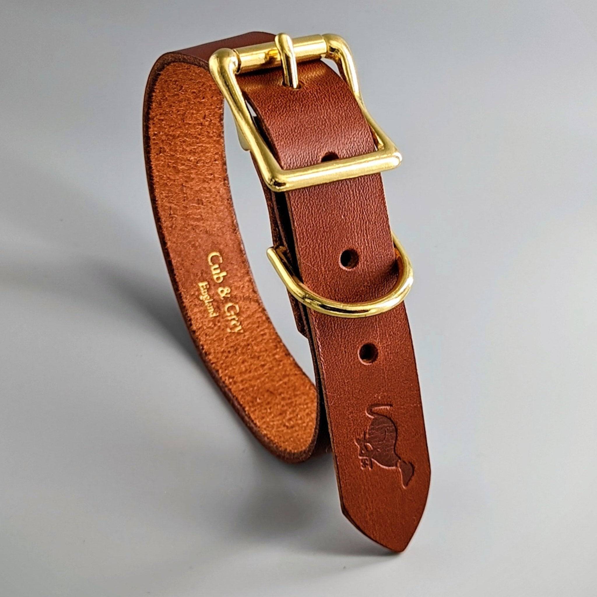 Brown personalised British leather dog collar featuring brass hardware and decorative embossed design details