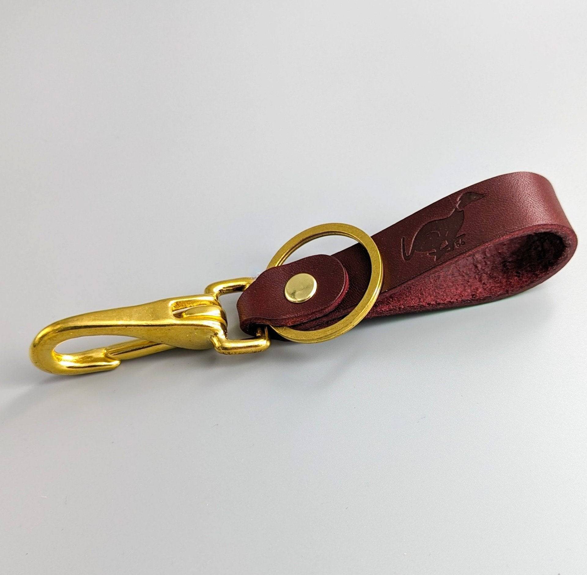 Burgundy personalised leather keyring with brass snap hook showing embossed details and quality British craftsmanship
