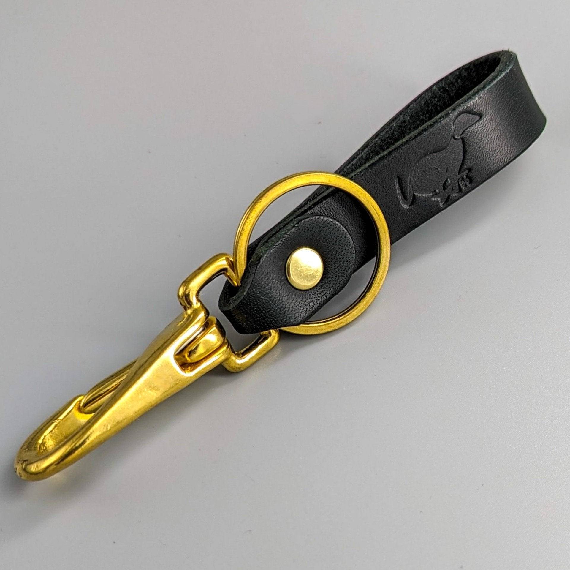 Black luxury leather keyring with gold hardware featuring embossed logo and premium British craftsmanship