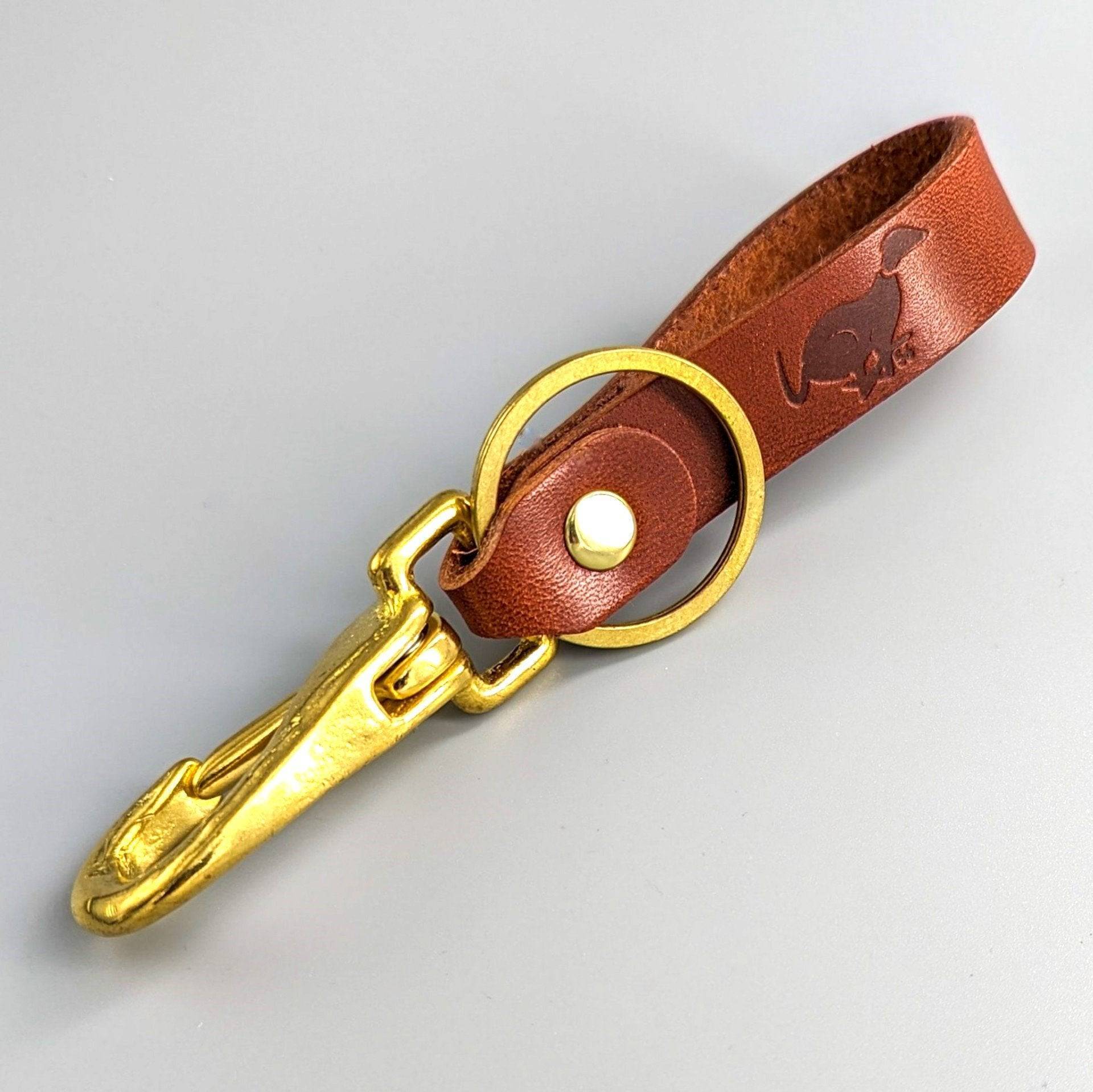 Brown luxury leather keyring with decorative embossed detailing, brass oval ring and lobster clasp hardware