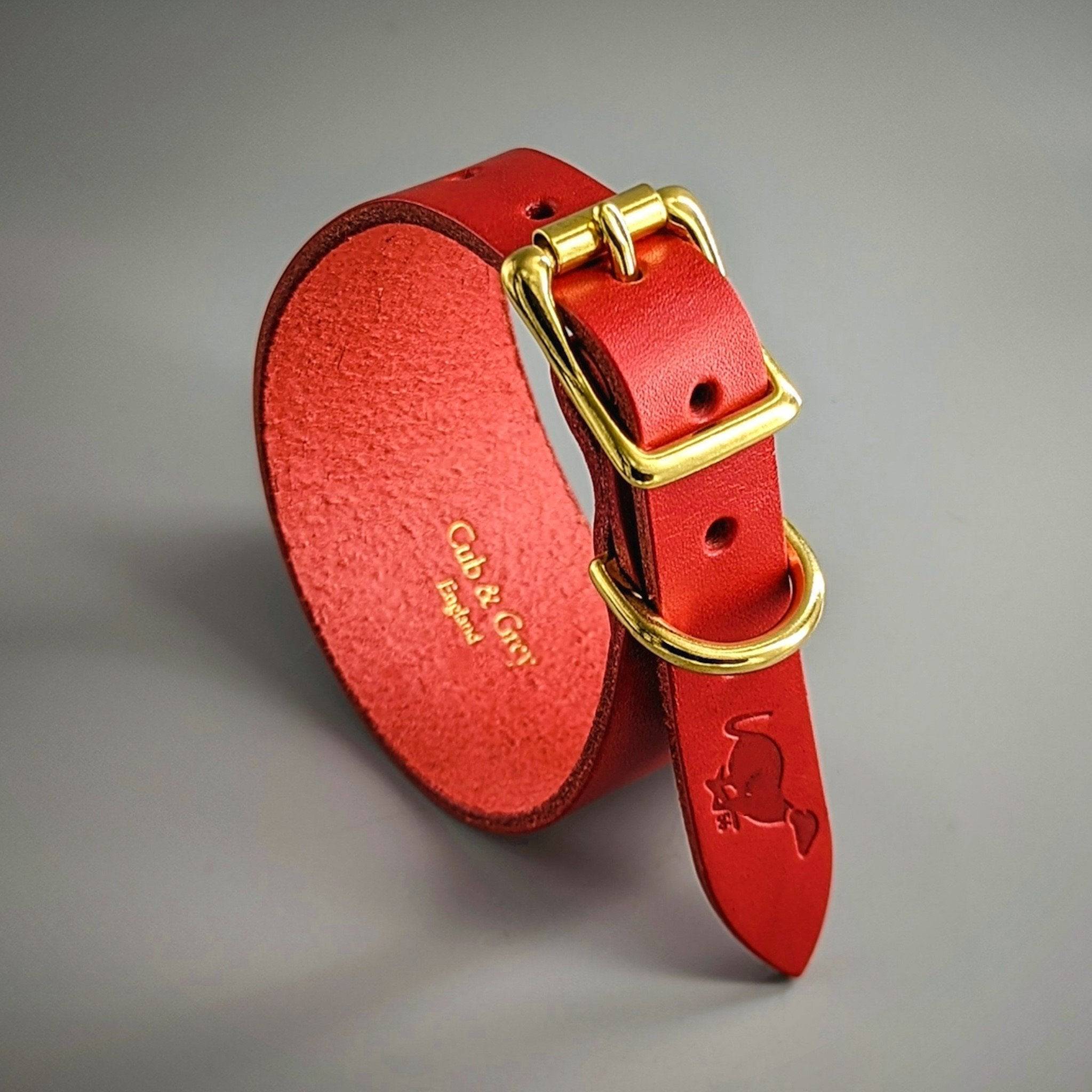 Red leather Cub & Grey dog collar interior showing the embossed Cub & Grey England maker's mark and brass buckle