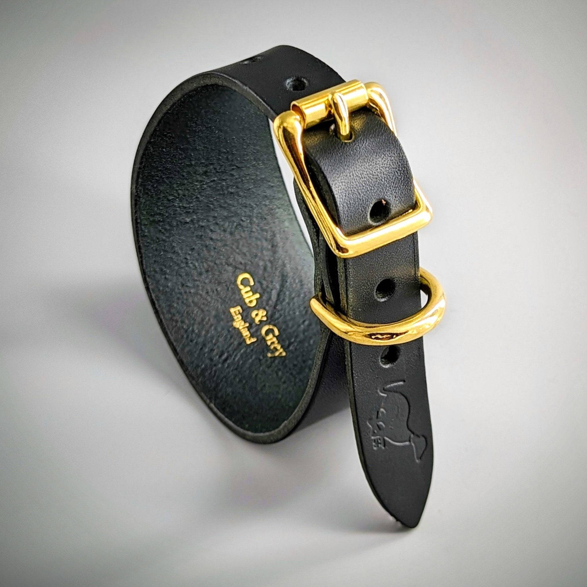 Black leather dog collar gold-tone buckle D-ring hardware, textured finish personalised branding interior text