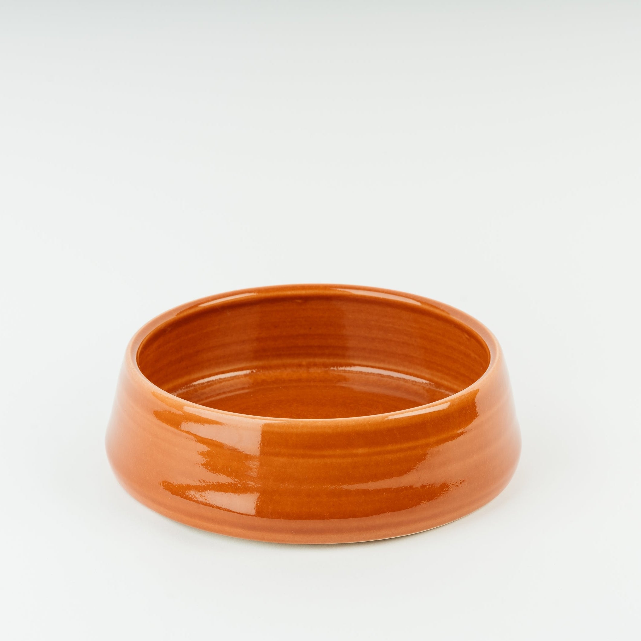 Handmade terracotta ceramic dog bowl with glossy finish, British stoneware crafted by Derbyshire artisan pottery