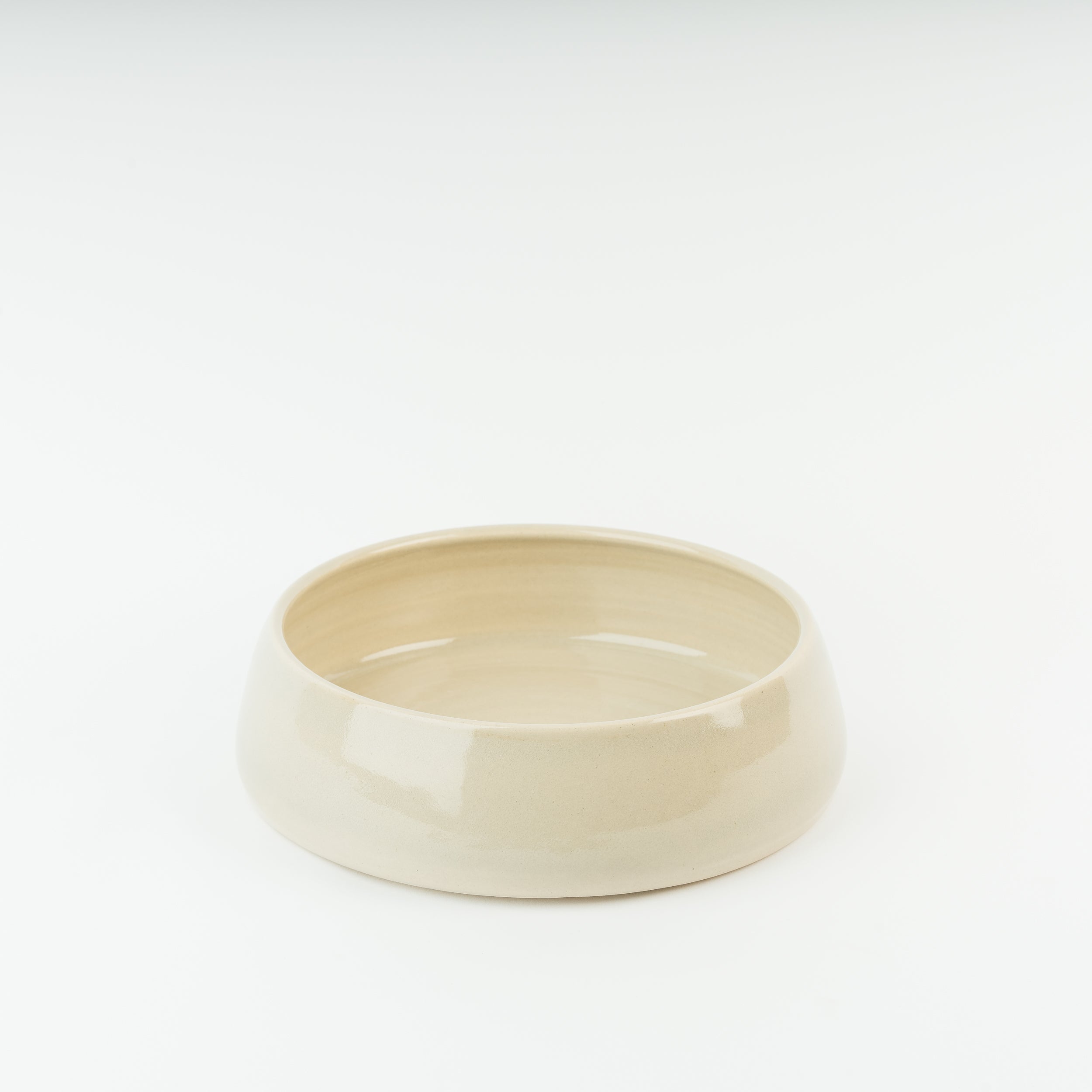 Handmade cream stoneware dog bowl by British artisan pottery, showcasing traditional Derbyshire craftsmanship