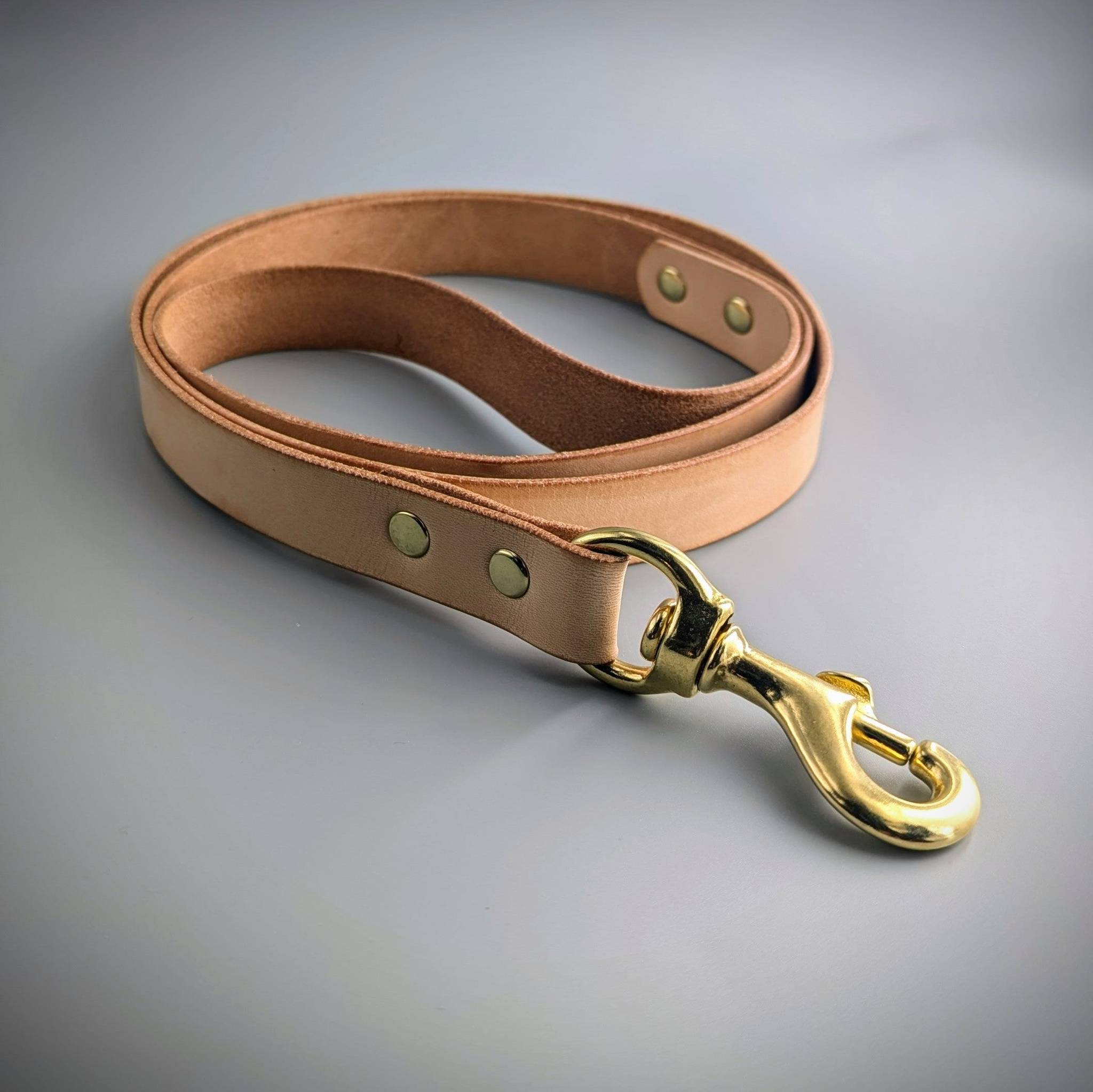 Cub & Grey Naked Leather Dog Lead with brass hardware on a grey background