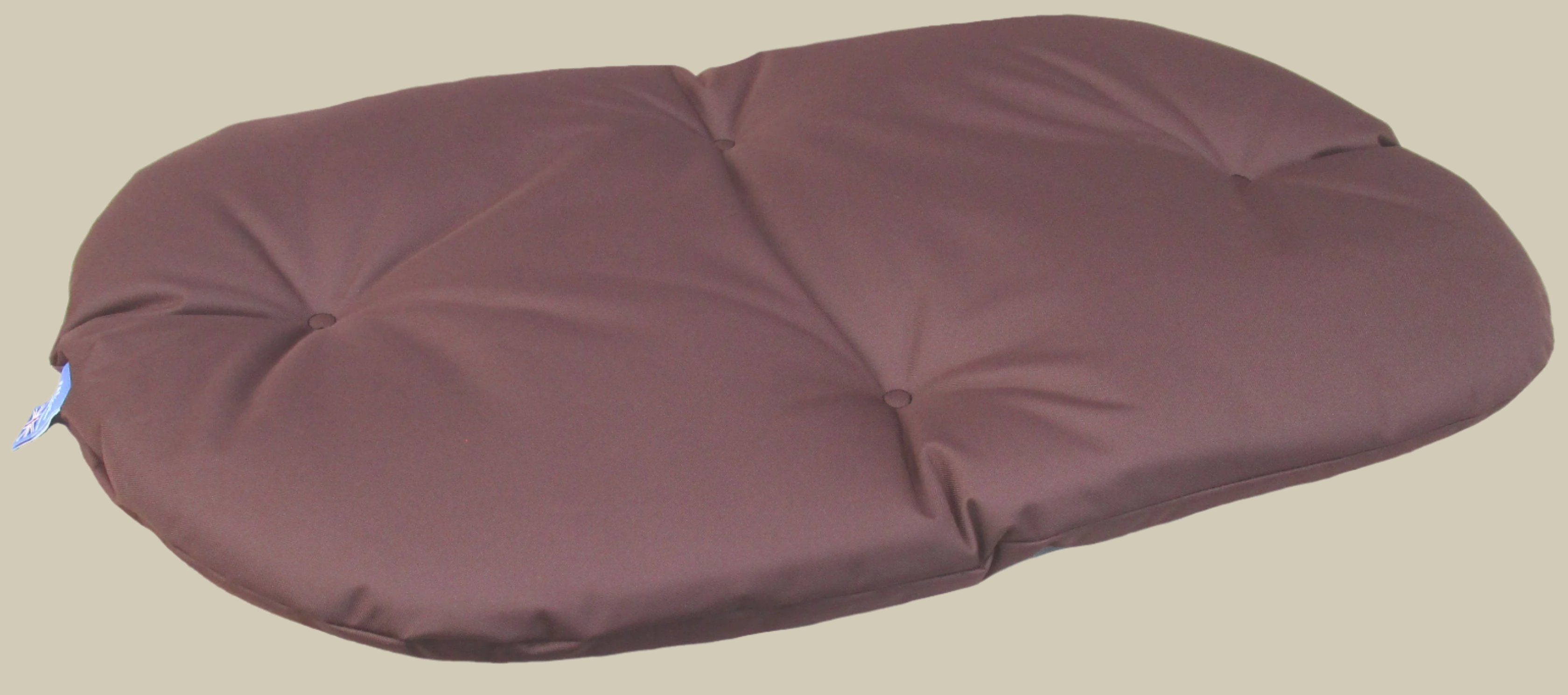 Brown waterproof oval dog bed cushion with quilted padding and durable fabric construction for comfortable pet sleep