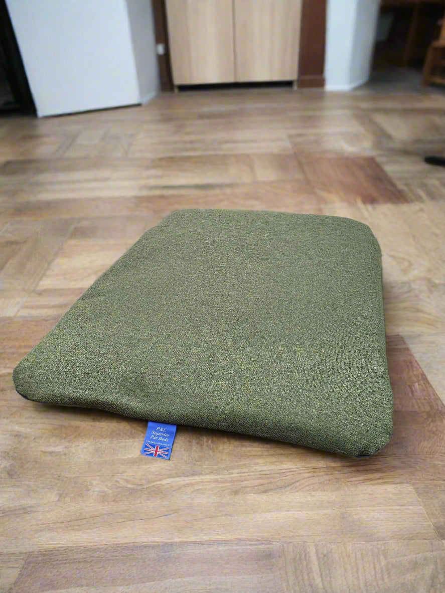 Green Orkney tweed dog bed cover with Union Jack label on wooden floor showing quality UK-made pet bedding