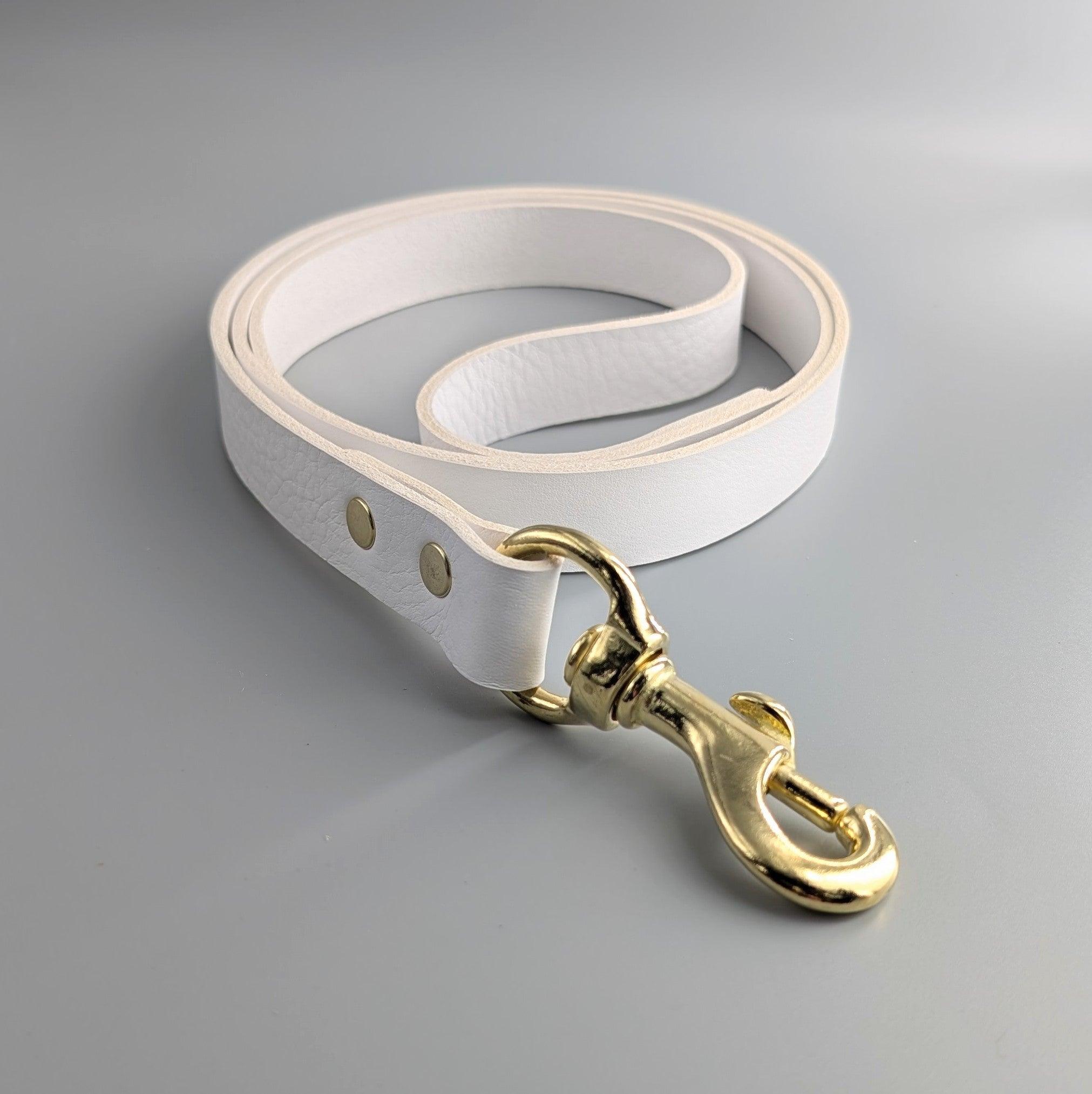 Cub & Grey Leather Dog Lead in white with brass hardware on a grey background