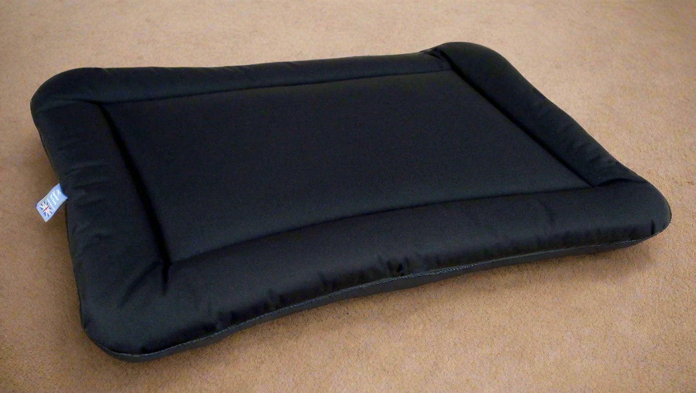 Black waterproof rectangular dog bed cushion pad by P&L Country Dog on beige carpet showing durable design