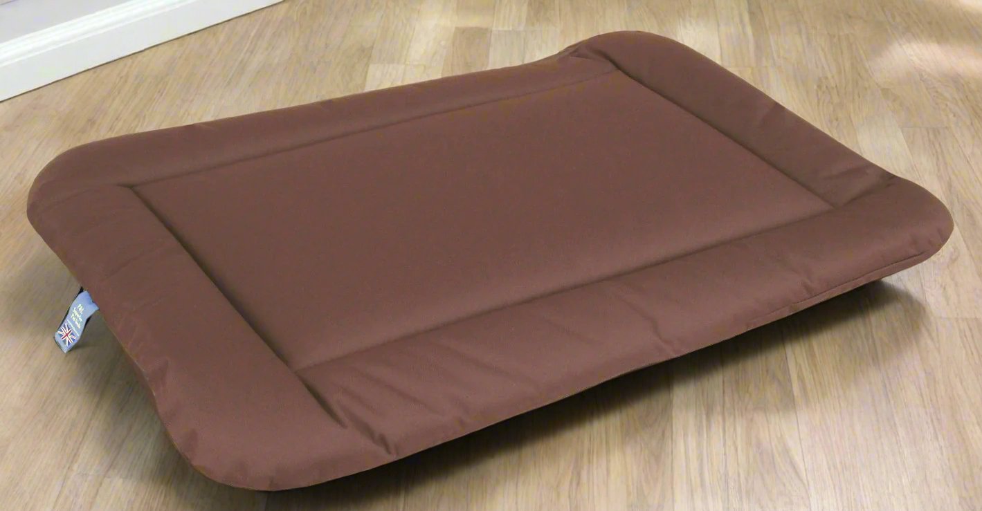 Brown waterproof rectangular dog bed cushion pad on wooden floor showing durable heavy duty construction