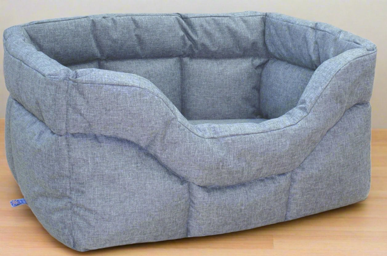 Grey heavy duty rectangular waterproof dog bed with high sides and quilted fabric construction on wooden floor