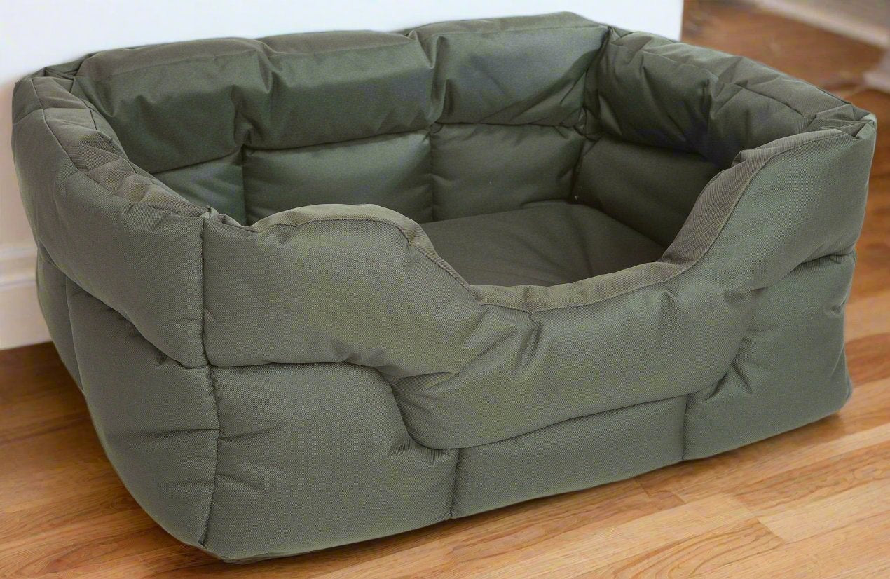Country Dog heavy duty rectangular dog bed in olive green with high padded sides and waterproof fabric on wooden floor