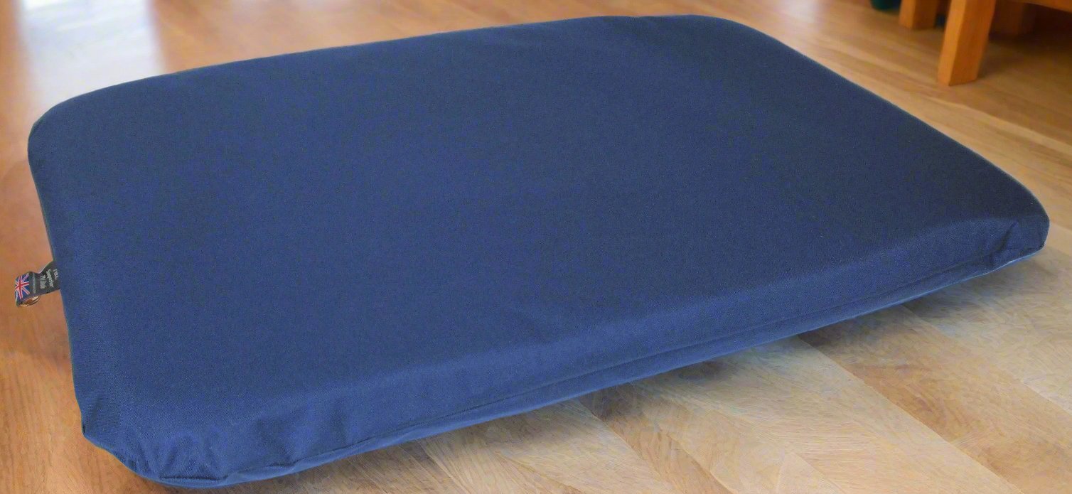 Navy blue waterproof dog bed with heavy duty cover on wooden floor, showing durable construction and quality materials