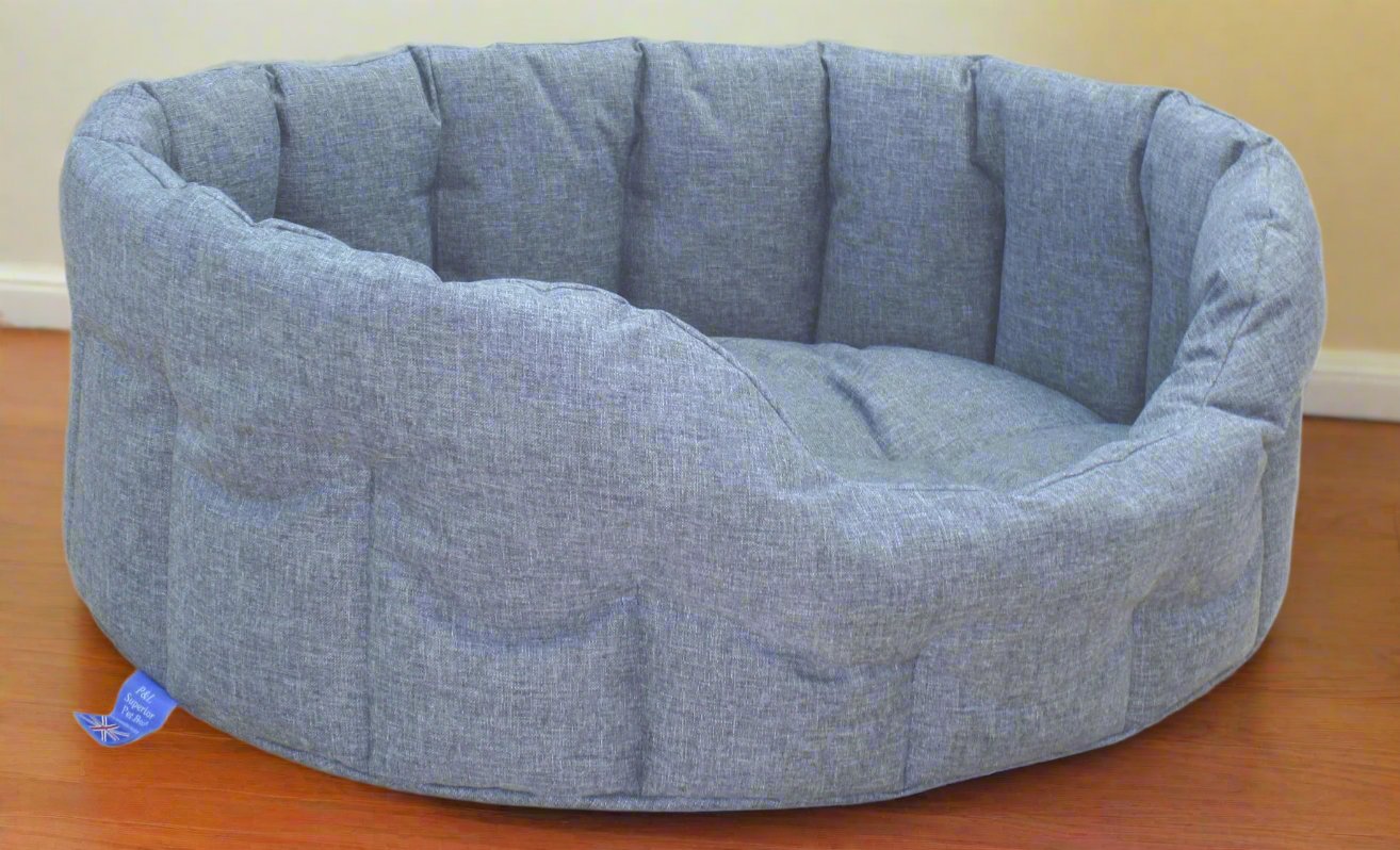 Grey Orkney tweed oval high sided waterproof dog bed with quilted interior and blue P&L Country Dog brand label