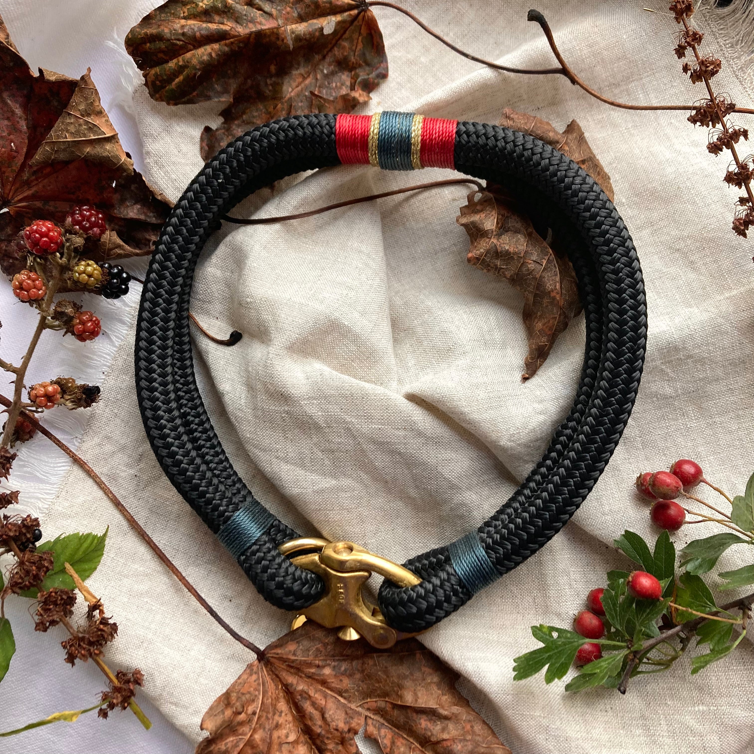 Close-up of Oonalfie Royal collar showing nautical whipping detail in red, blue and gold thread