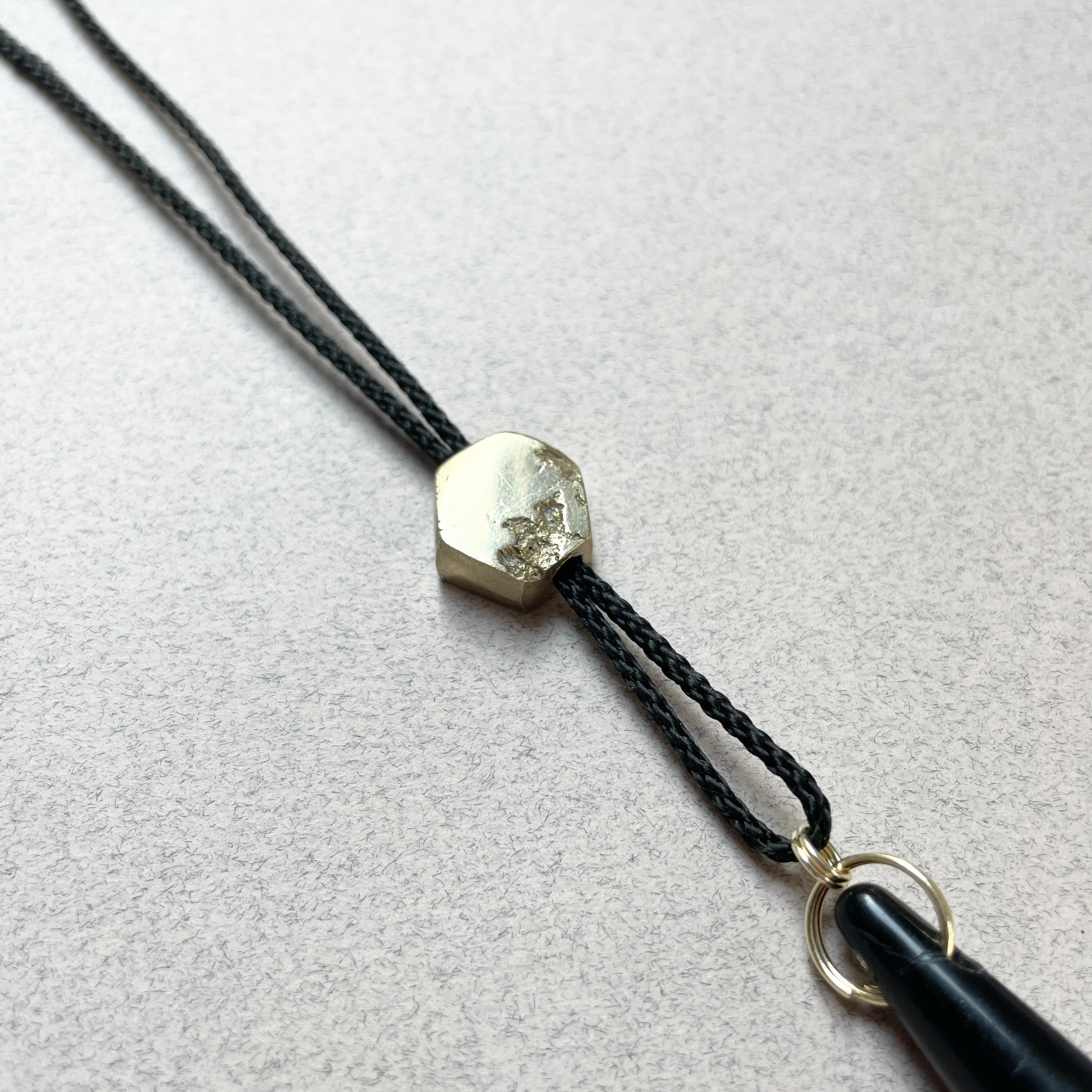 Black and Gold whistle lanyard by Oonalfie showing full length rope construction