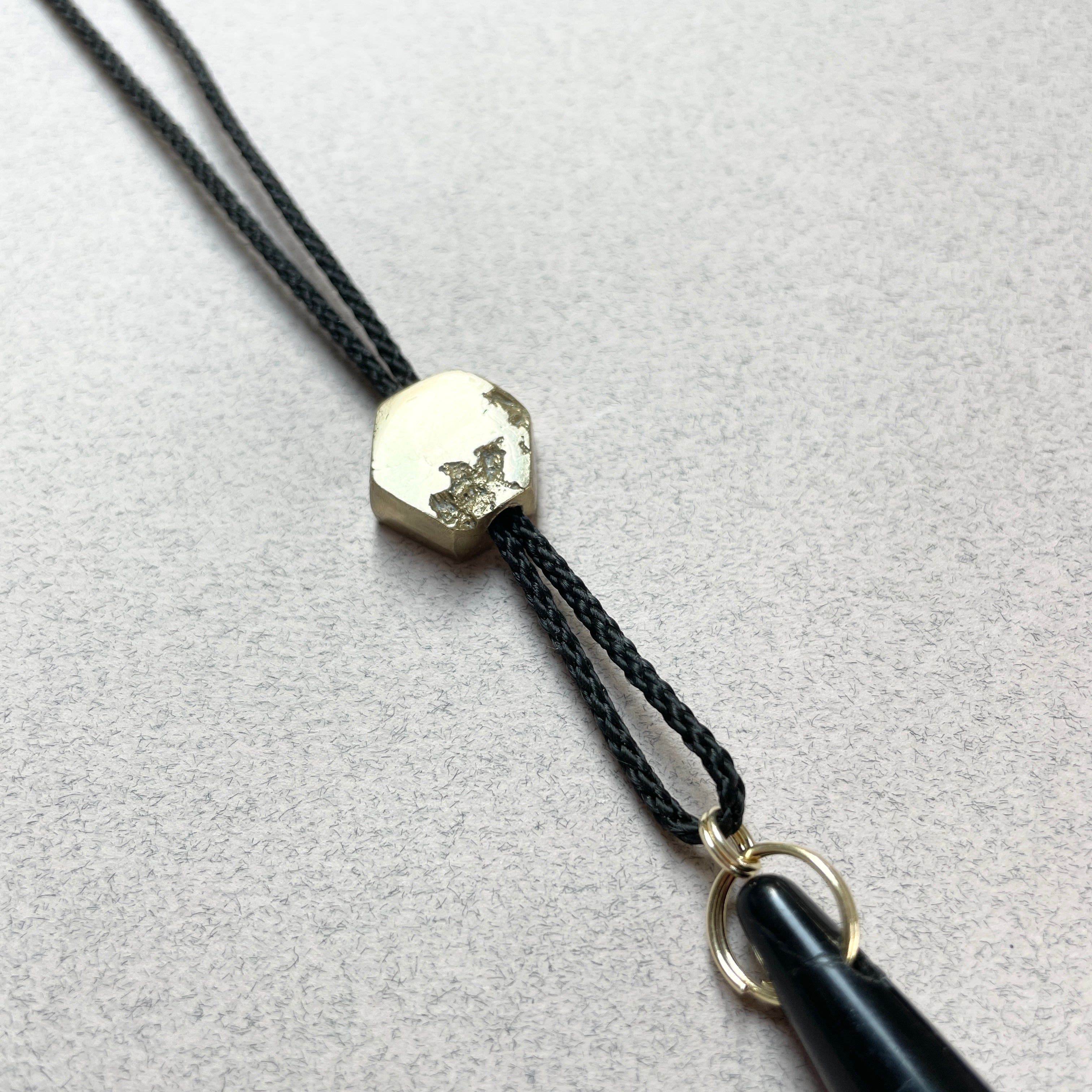 Oonalfie black and gold whistle lanyard with solid brass hardware, handmade in Britain