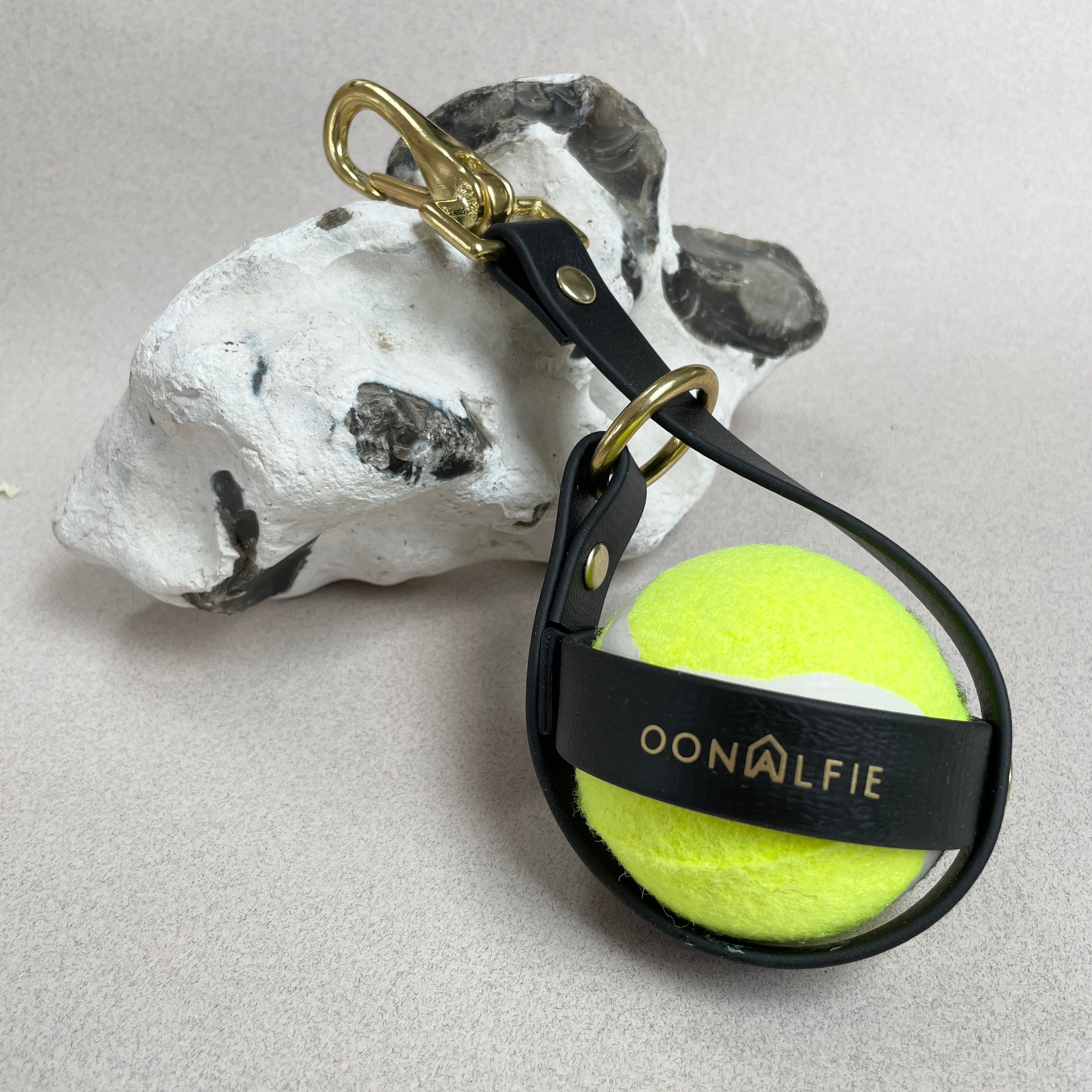 Oonalfie dog ball holster in marine-grade rope with solid brass hardware, clips to lead or belt loop