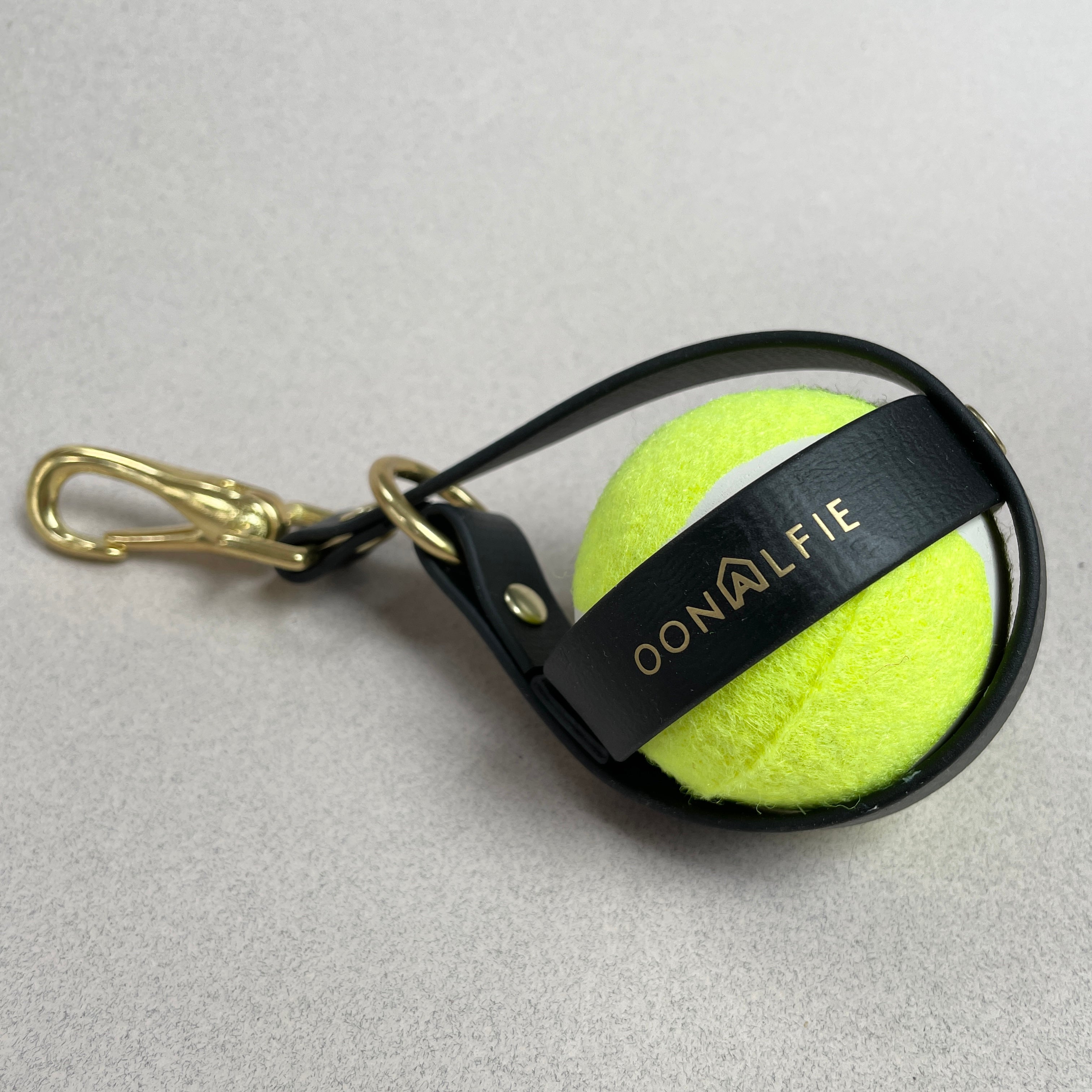 Close-up of Oonalfie ball holster showing rope construction and brass clip hardware