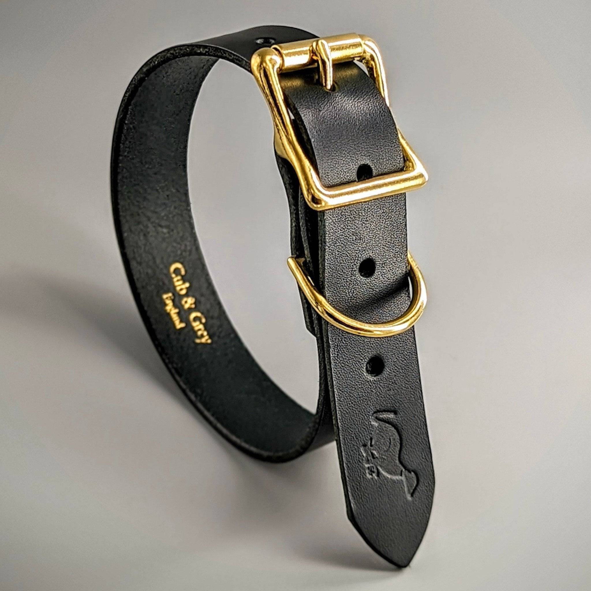 Black British leather dog collar with brass hardware and Gub & Gal branding, demonstrating custom options