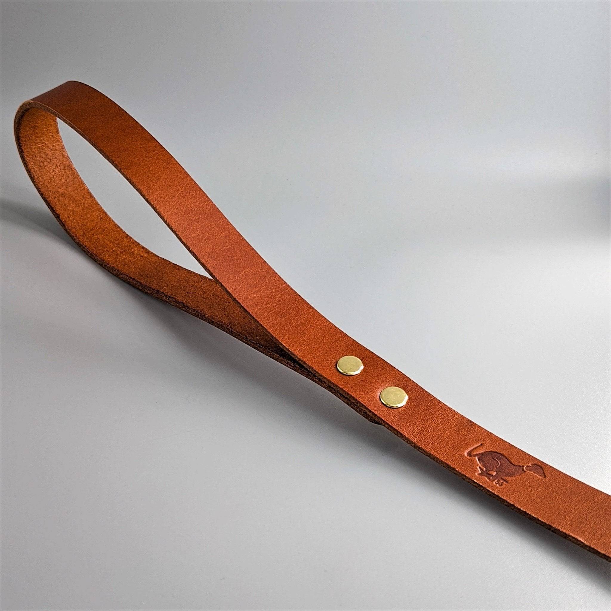 Tan cognac leather Cerberus dog leash with brass rivets, embossed logo and premium craftsmanship styling