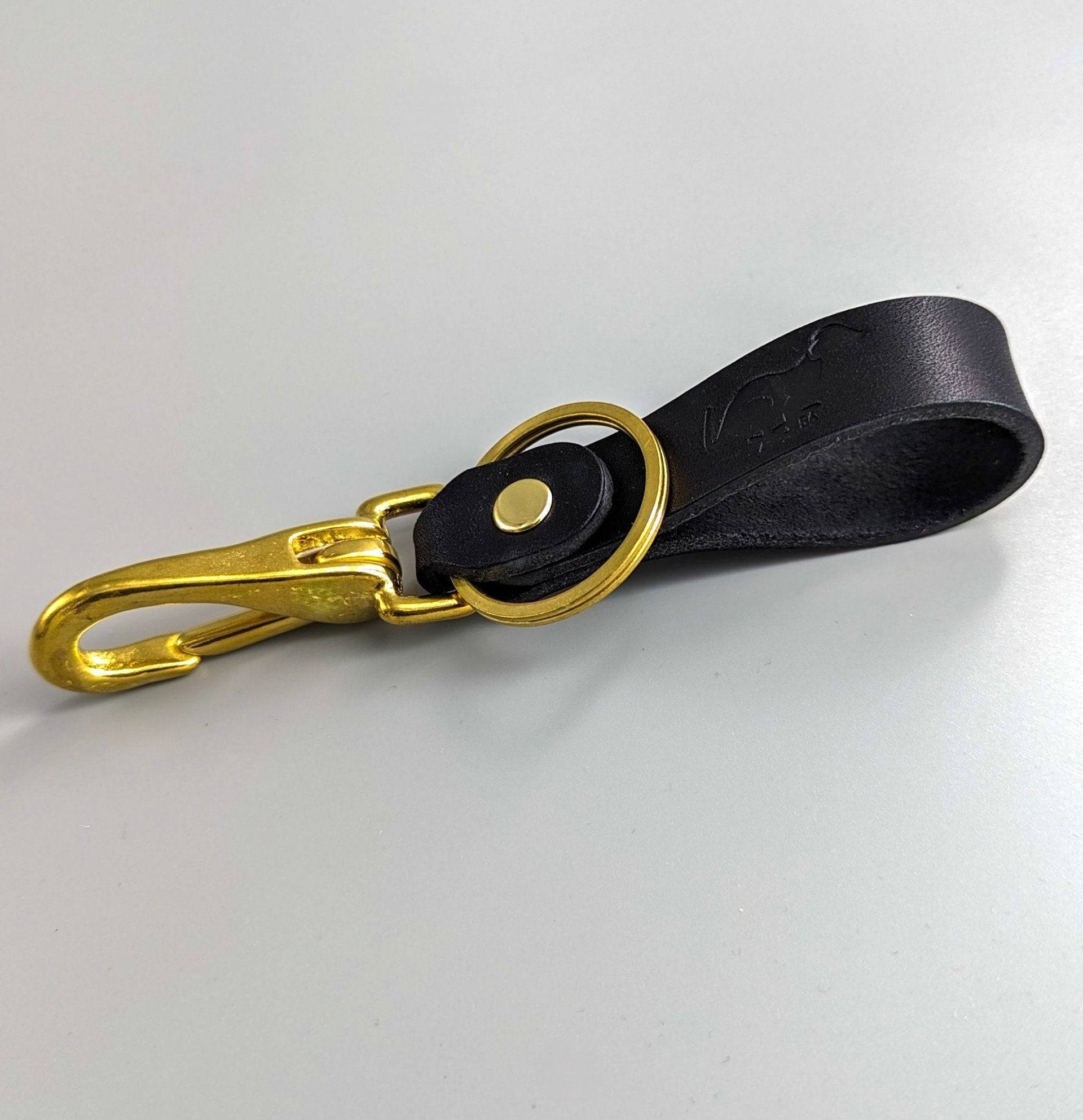 Black bespoke British leather keyring with embossed medallion, gold hardware and premium stitching craftsmanship