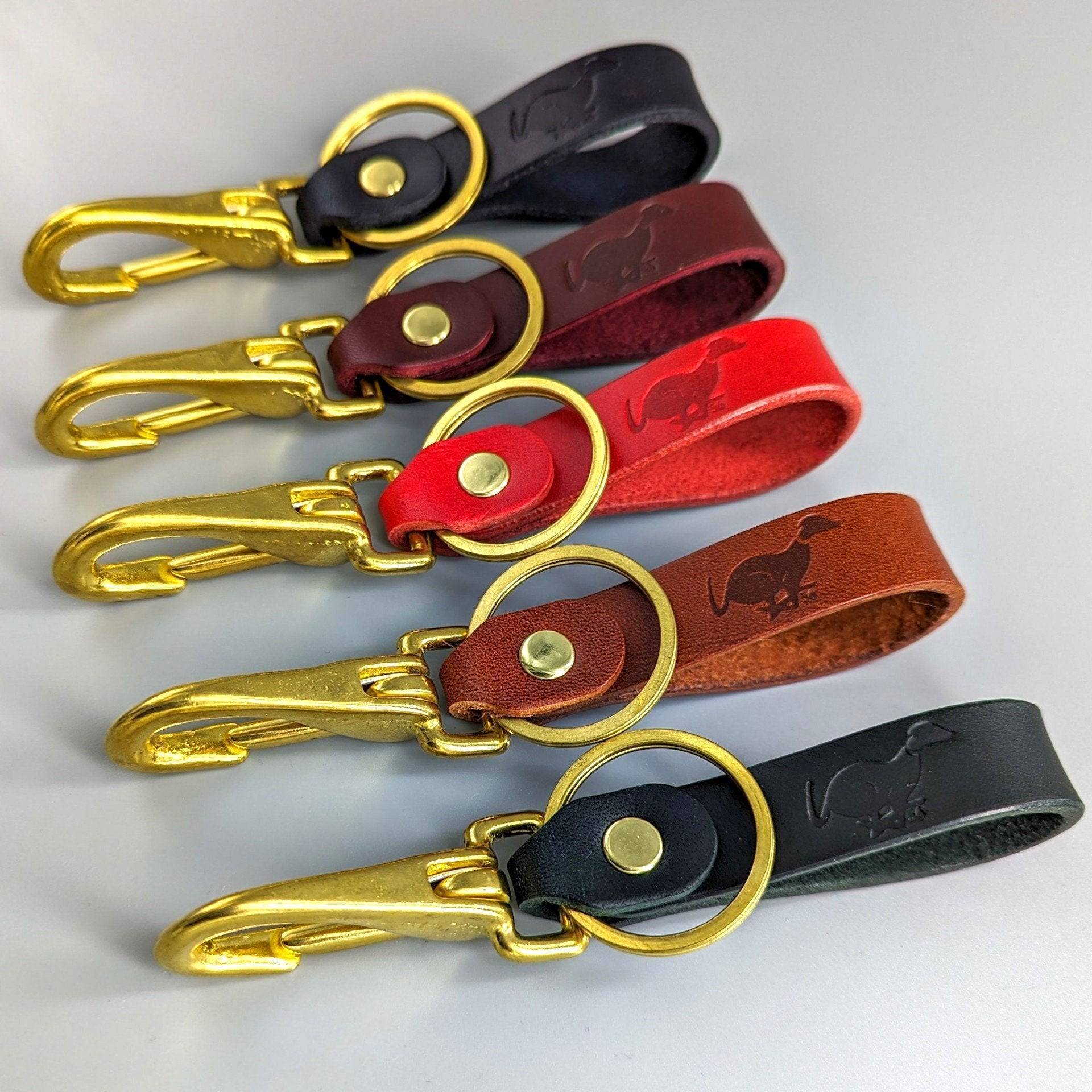 Five luxury British leather keyrings in black, burgundy, red, brown, green with embossed designs and gold hardware