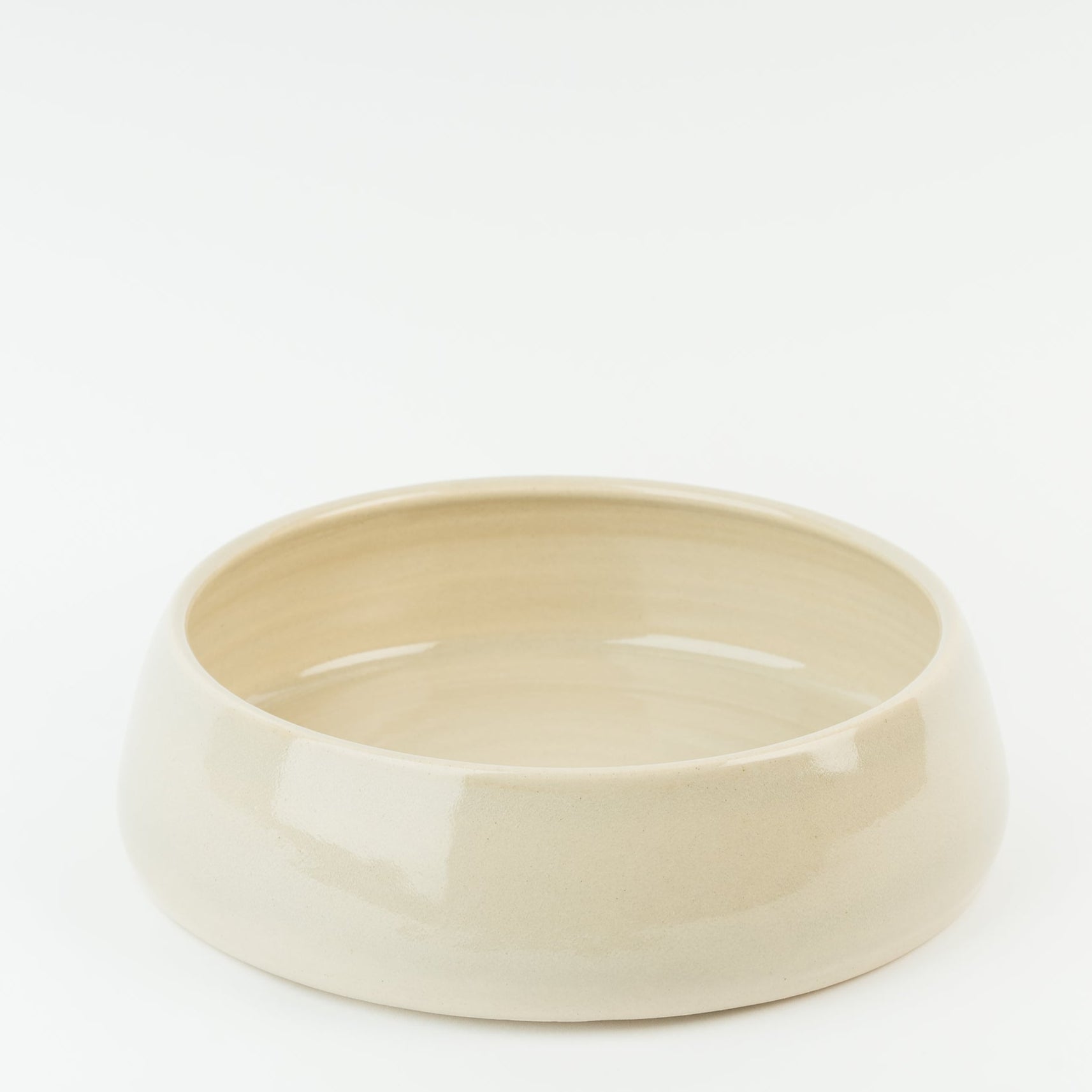Large handmade ceramic dog bowl in cream stoneware, showcasing traditional British pottery craftsmanship