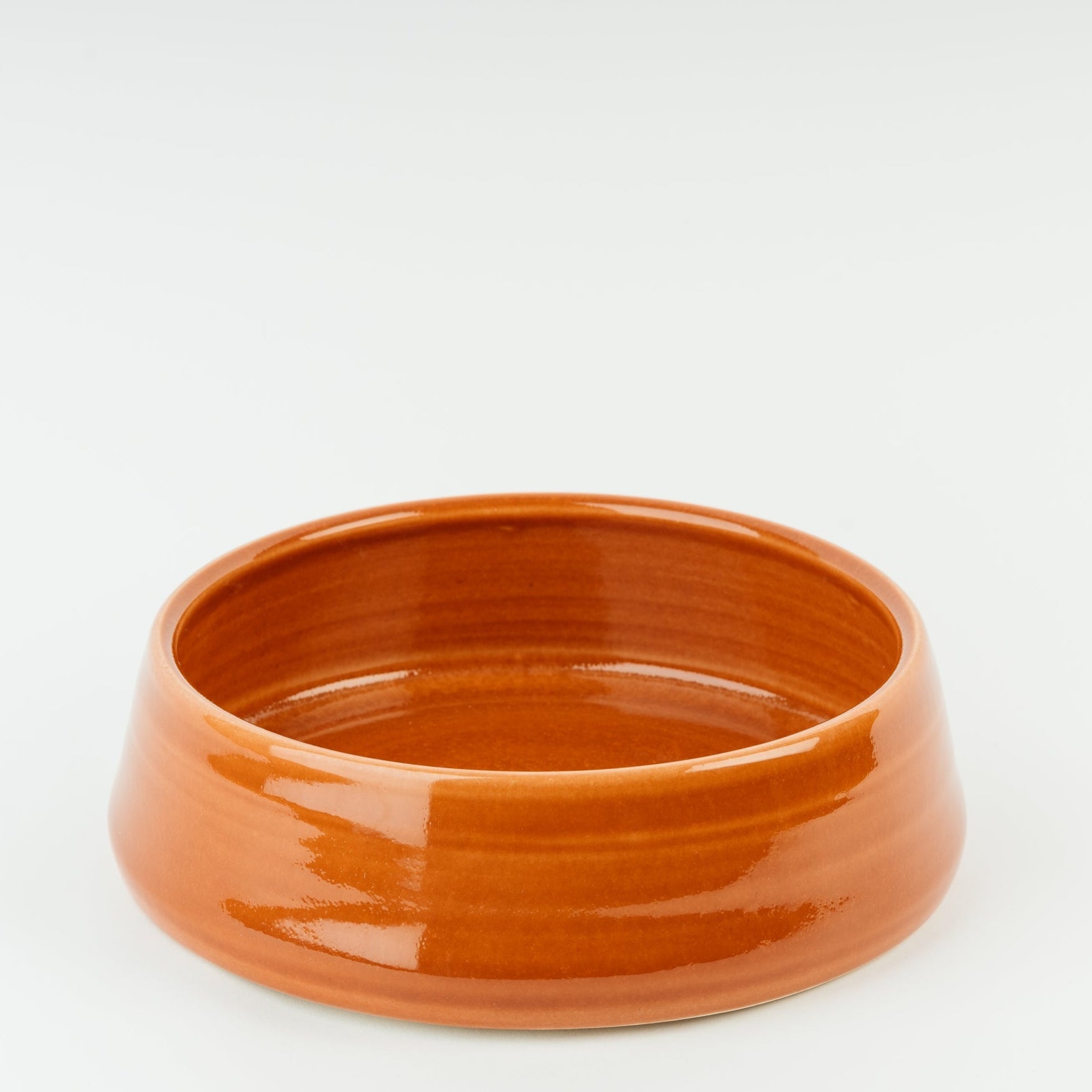 Handmade terracotta ceramic dog bowl with glossy finish, British Derbyshire stoneware crafted by artisan potters