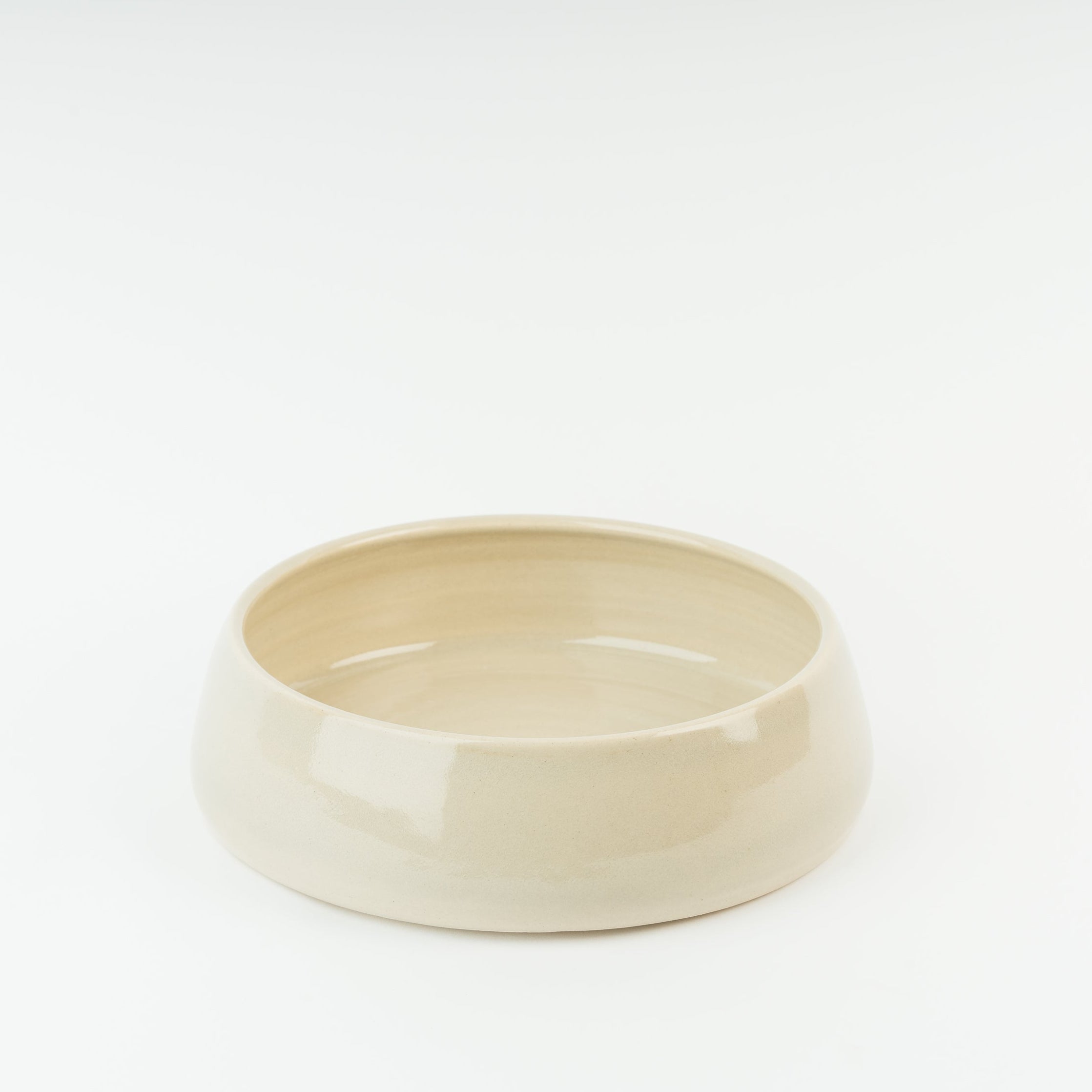 Handmade cream stoneware dog bowl by Wirksworth Pottery, showing traditional British ceramic craftsmanship