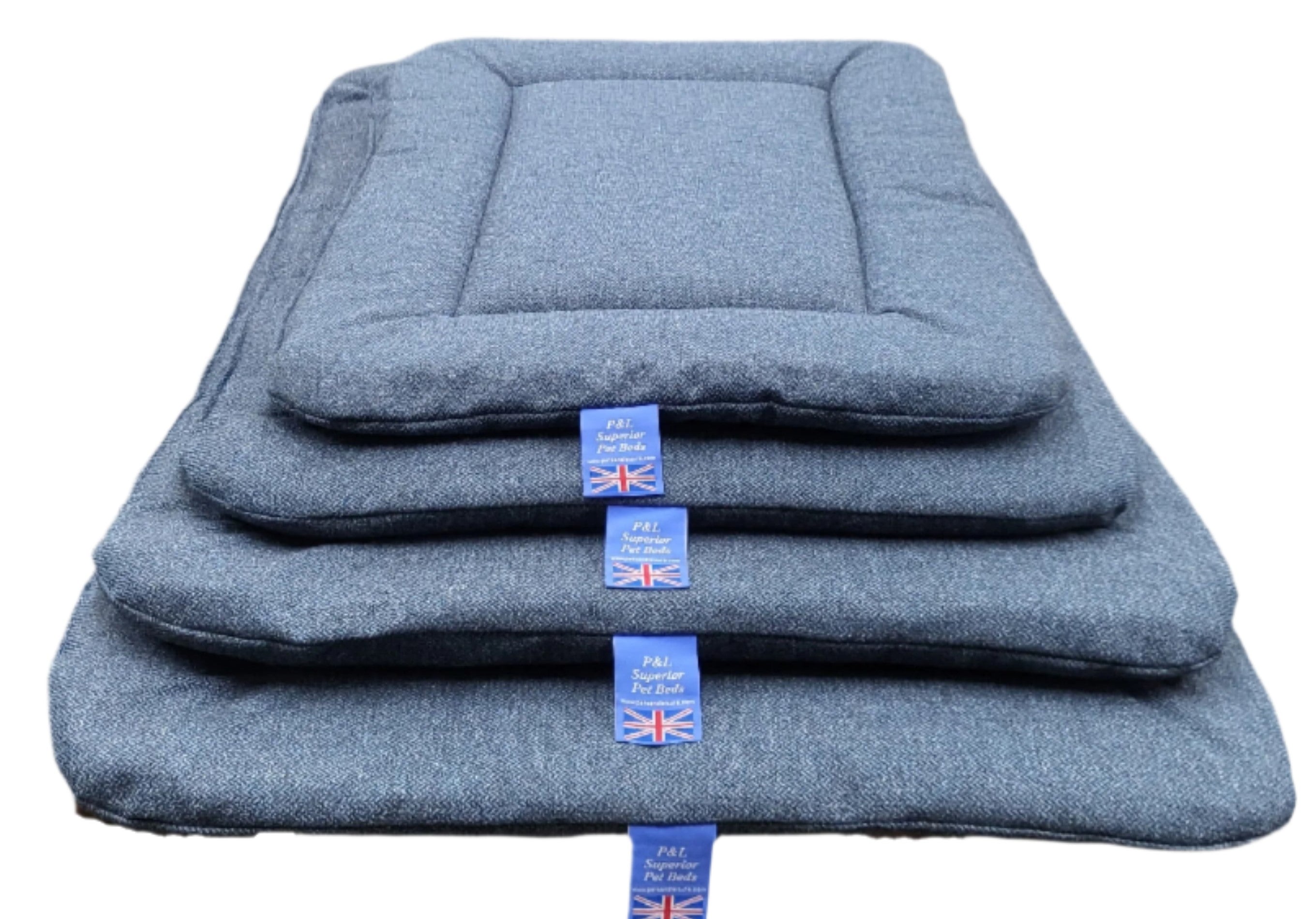 Stack of grey Orkney tweed rectangular dog bed pads in multiple sizes with British flag labels from P&L