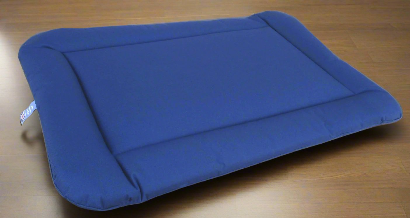 Blue waterproof rectangular dog bed cushion pad by P&L Country Dog on wooden floor showing durable design