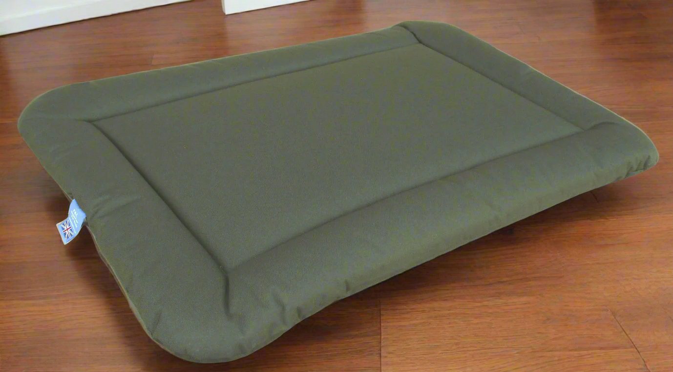 Olive green waterproof rectangular dog bed cushion pad on wooden floor showing durable heavy duty construction