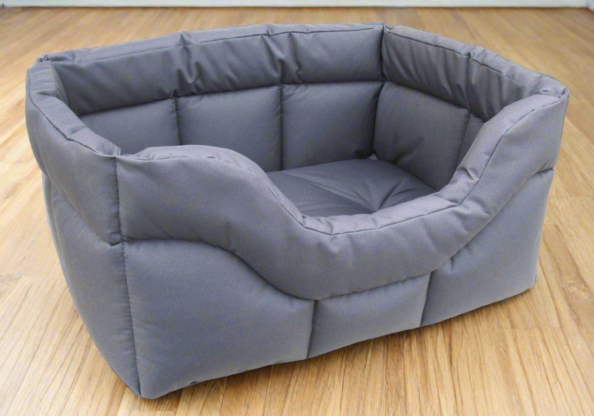 Grey waterproof rectangular dog bed with high padded sides and cushioned base on wooden floor
