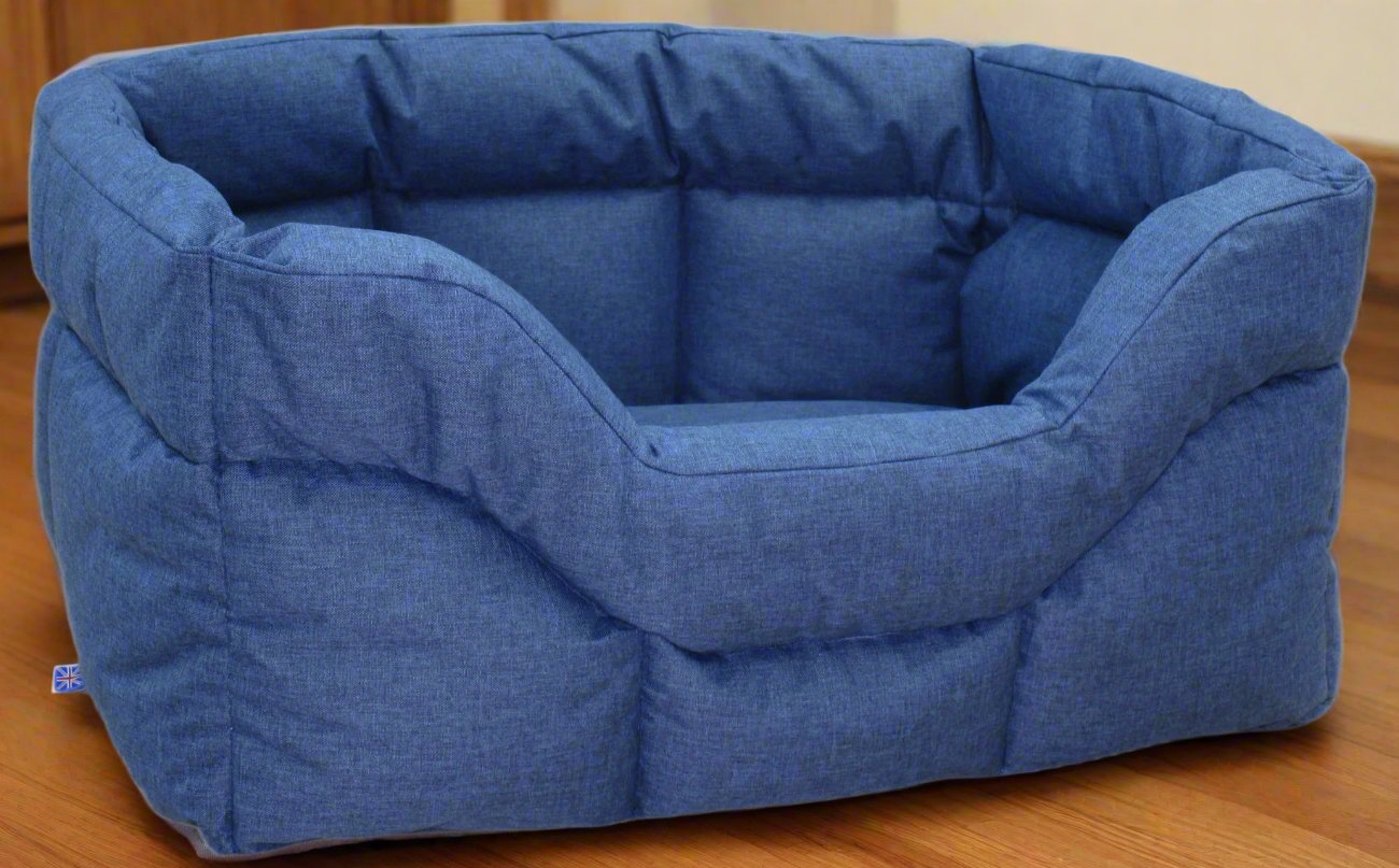Blue heavy duty rectangular high sided waterproof dog bed with quilted padding on wooden floor