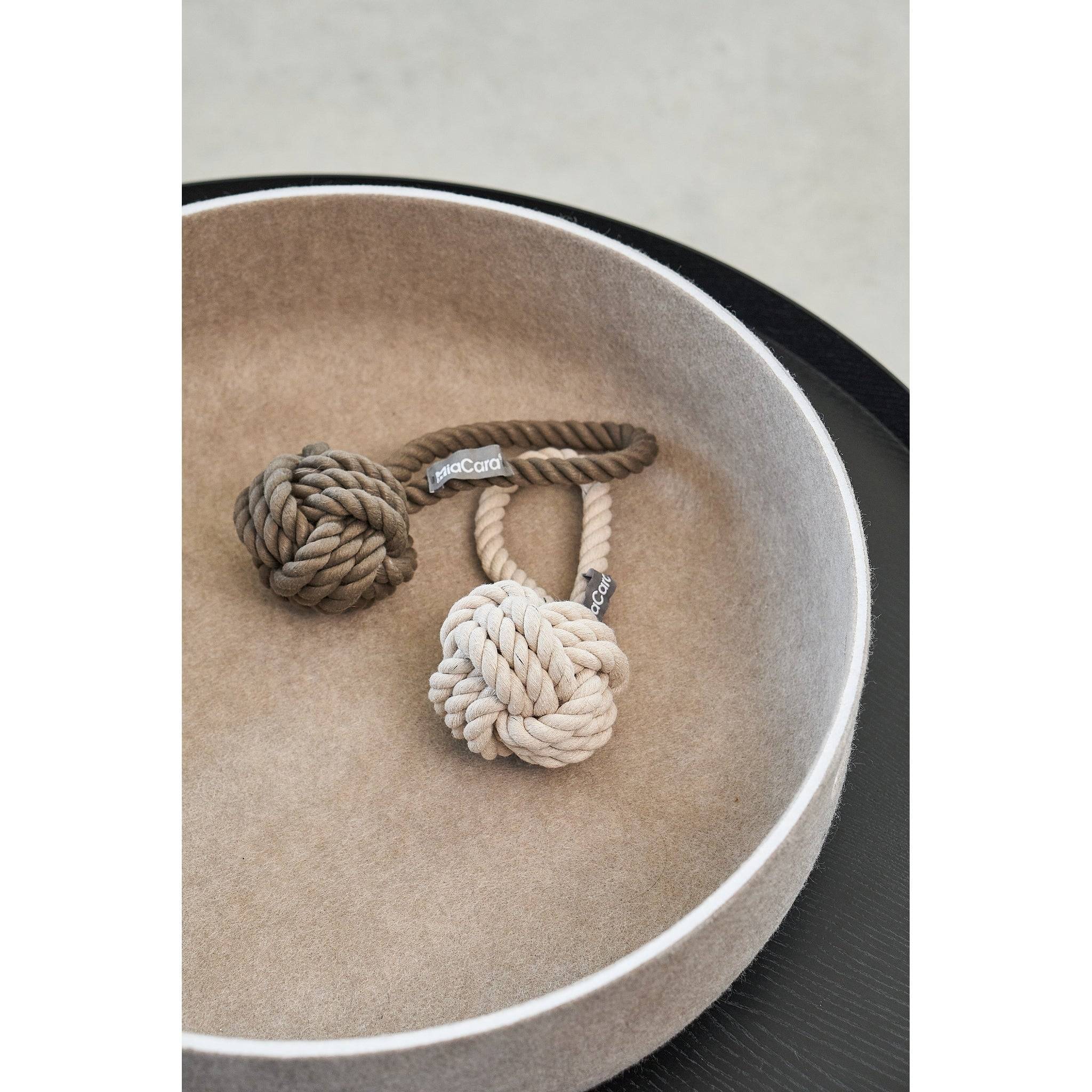 MiaCara Cesto designer pet toy basket in beige with rope toys, showcasing minimalist German design for modern homes