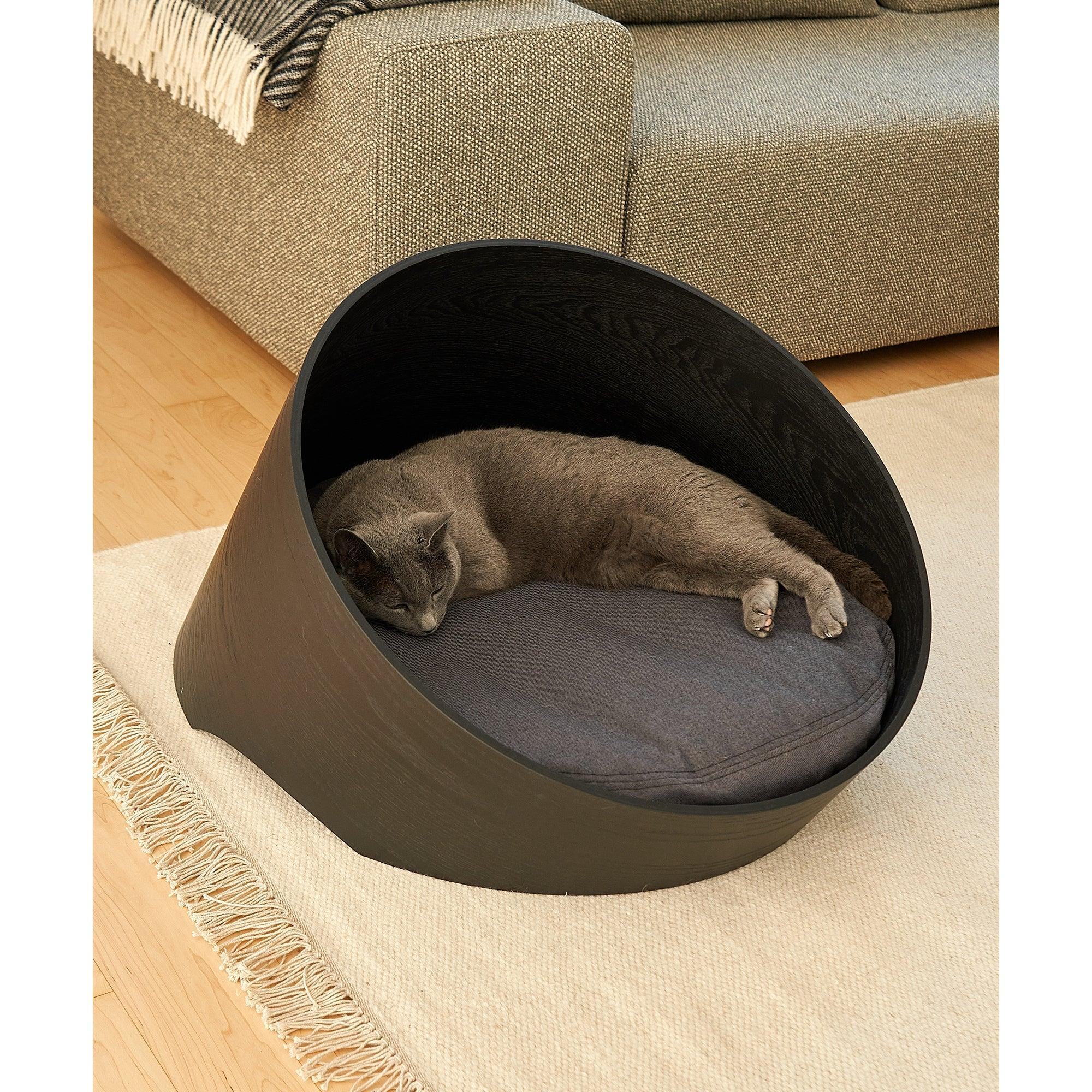 MiaCara Covo designer cat basket in charcoal with grey cat sleeping inside, modern minimalist pet furniture