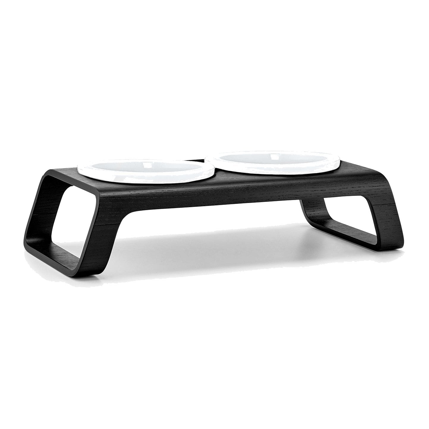 Modern black wooden cat feeder with two white porcelain bowls, minimalist German design for contemporary homes