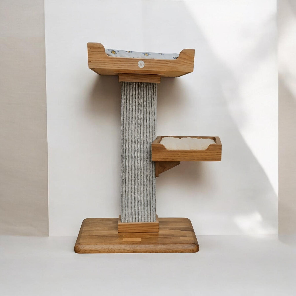 Handmade cat tree with two beds on one sisal carpet post and a solid oak base, front view
