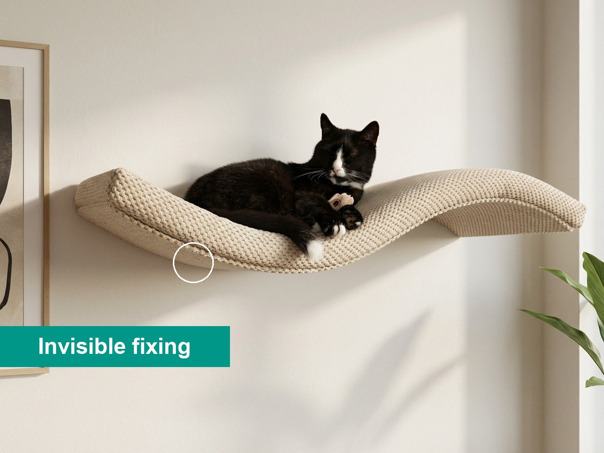 A black and white cat resting on a beige Cat's Atelier Floating Cat Wall Shelf