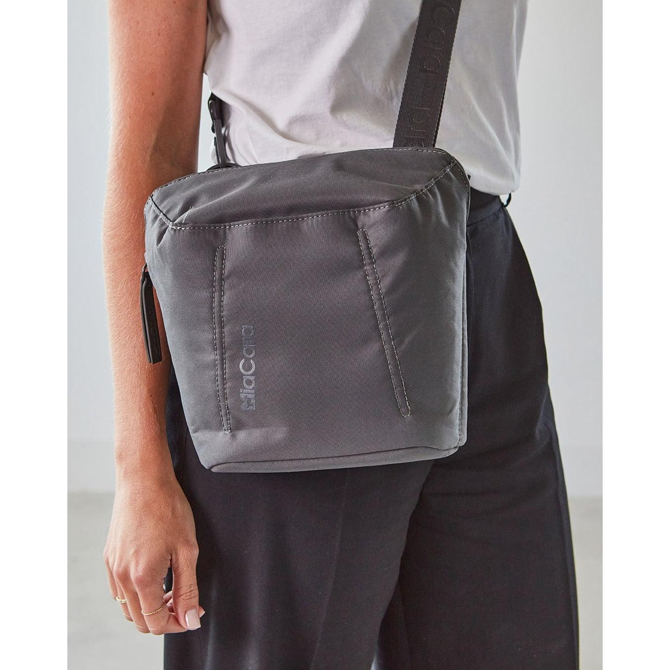 German-designed MiaCara Urbano grey crossbody pet carrier bag worn by person in minimalist contemporary style